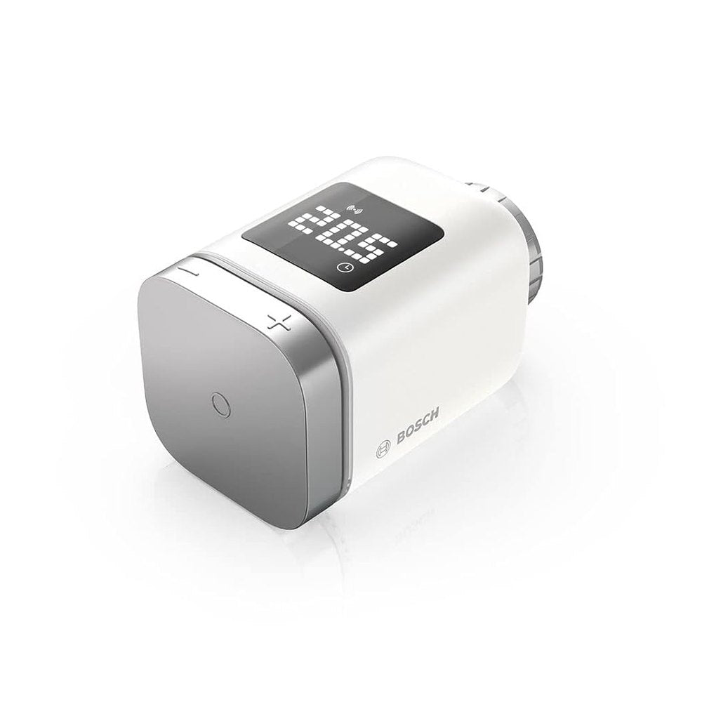 Bosch Smart Home Radiator Thermostat II, a compact intelligent temperature controller designed for customizable heating in each room, compatible with Amazon Alexa, Google Assistant, and Apple HomeKit. Includes 1 thermostat, 2 AA batteries, Danfoss RA and RAVL adapters, and a multilingual quick start guide.