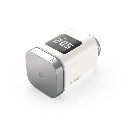 Bosch Smart Home Radiator Thermostat II, a compact intelligent temperature controller designed for customizable heating in each room, compatible with Amazon Alexa, Google Assistant, and Apple HomeKit. Includes 1 thermostat, 2 AA batteries, Danfoss RA and RAVL adapters, and a multilingual quick start guide.