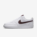 Nike Court Vision Low Next Nature sneakers with low-top design, perforated toe box, and rubber sole.