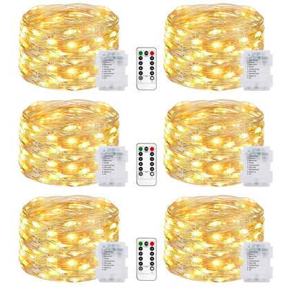Battery powered string lights in warm white, featuring six packs of twinkle lights with eight modes and a remote control, designed for outdoor use in gardens, bedrooms, parties, and Christmas patio decorations, all waterproof.
