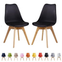 Set of 2 black retro dining chairs with cushioned seats and wooden legs