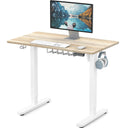 SHW Small Electric Height Adjustable Sit Stand Desk with white frame and maple top, featuring hanging hooks and cable managem