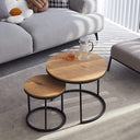 Set of 2 round nesting tables with light brown finish and wooden top, metal legs